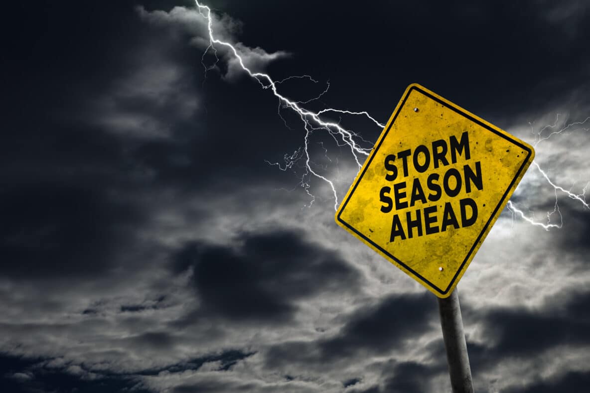 Storm season ahead road sign and lightning