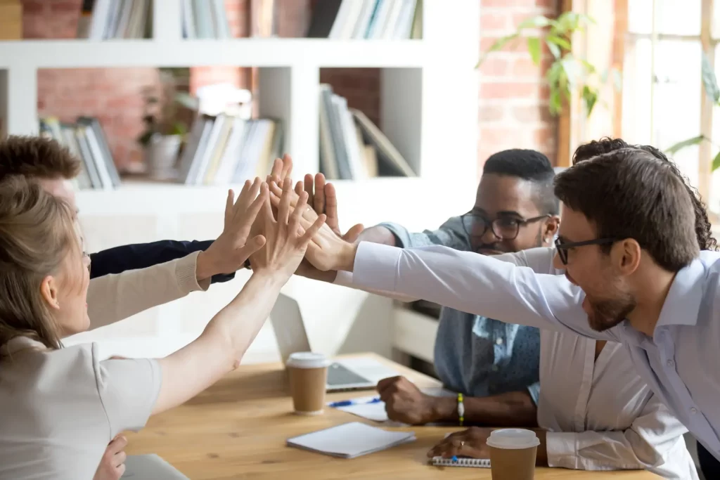 Team giving high five celebrating good results